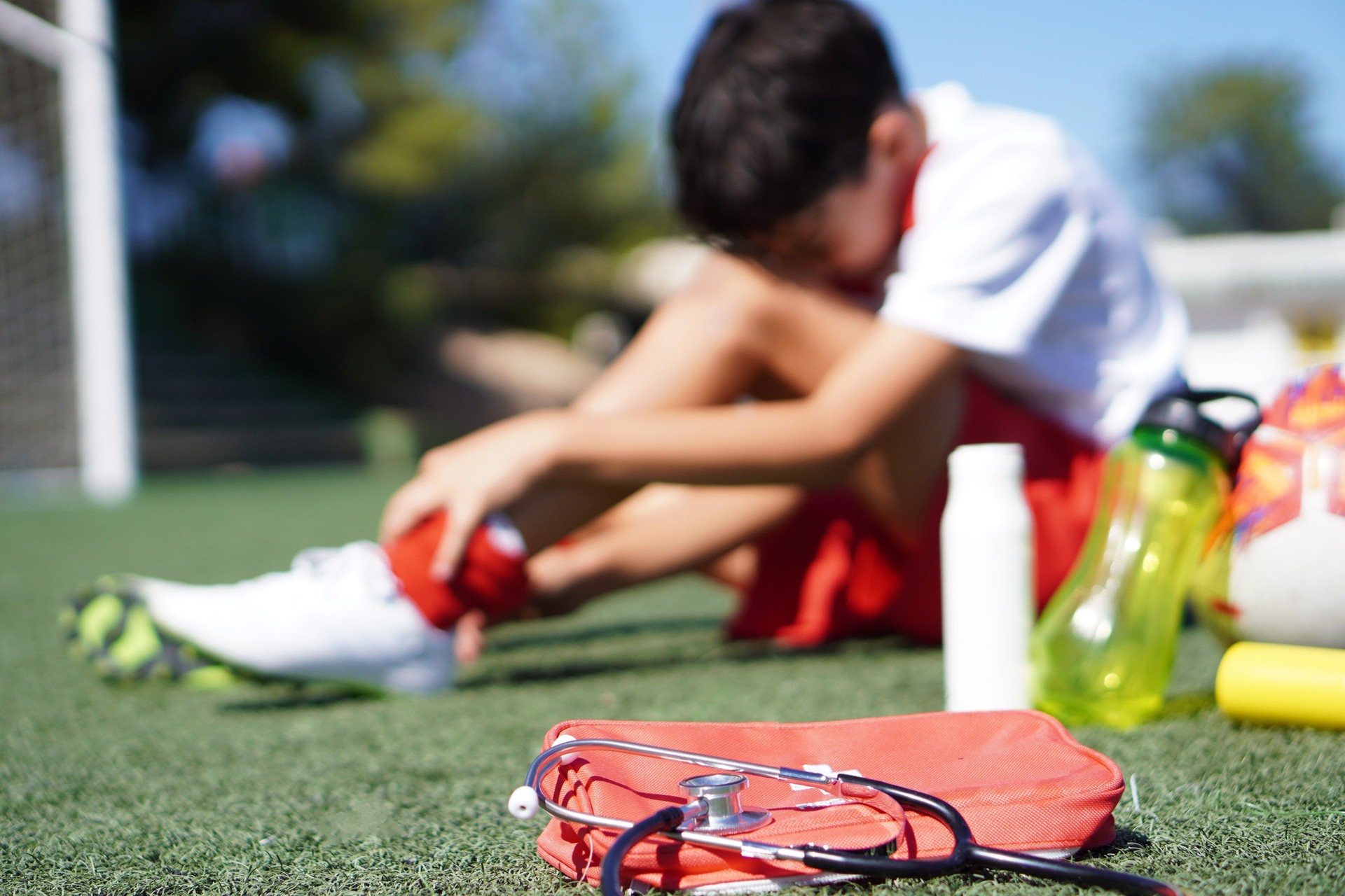faceless child injured during soccer game receiving medical assistance